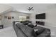 Comfortable living room featuring a large sectional, TV, and ample natural light from a bright window at 1052 Harlow'S Crossing Dr, Weddington, NC 28104