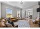 Bright living room featuring hardwood floors, neutral paint, and a cozy seating area at 1052 Harlow'S Crossing Dr, Weddington, NC 28104