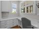 Well-lit office space with built-in cabinets, a spacious countertop, and ample natural light from the windows at 1052 Harlow'S Crossing Dr, Weddington, NC 28104