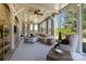 Inviting sunroom with floor-to-ceiling windows, a ceiling fan, and comfortable seating, overlooking a beautiful backyard at 1052 Harlow'S Crossing Dr, Weddington, NC 28104