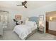 Cozy bedroom with neutral tones, stylish ceiling fan, plush carpeting, and a comfortable bed with decorative pillows at 1123 Park West Dr, Charlotte, NC 28209