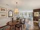 Spacious dining room with chandelier and ample seating that leads to living area at 1123 Park West Dr, Charlotte, NC 28209