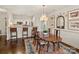 Inviting dining area with a wooden table, chandelier, and seamlessly connects to the kitchen at 1123 Park West Dr, Charlotte, NC 28209