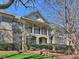 Stunning condo exterior showcasing a covered porch, brick accents, and lush landscaping at 1123 Park West Dr, Charlotte, NC 28209