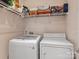 Functional laundry area with modern washer and dryer units, wire shelving, and essential laundry supplies for convenience at 1123 Park West Dr, Charlotte, NC 28209