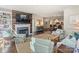 Cozy living area featuring a fireplace, comfortable seating, and seamless access to the dining area at 1123 Park West Dr, Charlotte, NC 28209
