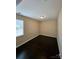 Bright bedroom featuring hardwood flooring and a large window at 11922 Kimberfield Rd # 37, Matthews, NC 28105