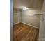 A walk-in closet with wood flooring and metal shelving offers storage and organization at 11922 Kimberfield Rd # 37, Matthews, NC 28105