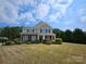 Traditional two-story house featuring a well-manicured lawn and classic architectural design at 11922 Kimberfield Rd # 37, Matthews, NC 28105