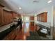 Open kitchen with stainless steel appliances, dark countertops, and dark wood flooring at 11922 Kimberfield Rd # 37, Matthews, NC 28105