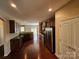 Open-concept kitchen with stainless steel appliances, granite countertops, and dark wood cabinetry at 11922 Kimberfield Rd # 37, Matthews, NC 28105