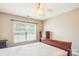 Cozy bedroom with natural light from the window and neutral colored walls at 12027 Stratfield Place Cir, Pineville, NC 28134