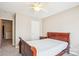 Cozy bedroom featuring soft carpet, a comfortable bed, and ample natural light from the nearby window at 12027 Stratfield Place Cir, Pineville, NC 28134
