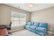 Bedroom showcases a bright window, a comfortable couch, and neutral walls over carpet at 12027 Stratfield Place Cir, Pineville, NC 28134
