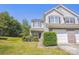 Charming two-story townhouse with a brick facade and attached garage, surrounded by lush landscaping at 12027 Stratfield Place Cir, Pineville, NC 28134