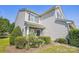 Attractive two-story townhouse featuring tidy landscaping, a partial brick facade, and an attached one-car garage at 12027 Stratfield Place Cir, Pineville, NC 28134