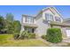 Inviting two-story townhouse with well-maintained lawn, brick accents, and an attached single car garage at 12027 Stratfield Place Cir, Pineville, NC 28134