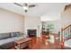 Comfortable living room with a fireplace, modern ceiling fan and hardwood floors at 12027 Stratfield Place Cir, Pineville, NC 28134