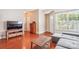 Comfortable living room featuring hardwood floors, ample natural light, and modern furnishings at 12027 Stratfield Place Cir, Pineville, NC 28134