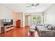 Inviting living room with hardwood floors, a cozy sofa, and great natural light from a bright window at 12027 Stratfield Place Cir, Pineville, NC 28134