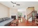 Inviting living room featuring a cozy fireplace and hardwood floors leading to the dining area at 12027 Stratfield Place Cir, Pineville, NC 28134