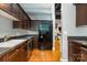 Traditional kitchen with wooden cabinets, stainless steel appliances, and a refrigerator at 127 N Tryon St # 301, Charlotte, NC 28202