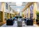 Bright and spacious lobby featuring contemporary furniture, large windows, and stylish decor and plants at 127 N Tryon St # 301, Charlotte, NC 28202