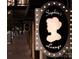 Sophia's Lounge sign along a sidewalk showcasing a vintage aesthetic in black, white and grey at 127 N Tryon St # 301, Charlotte, NC 28202