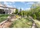 Picturesque backyard with terraced landscaping, a fire pit, and mature trees offering privacy at 1313 Loggerhead Dr, Lancaster, SC 29720