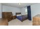 Cozy bedroom with wooden furniture, a comfortable bed, and natural light from the window at 1313 Loggerhead Dr, Lancaster, SC 29720