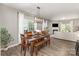 Bright dining area with wooden table set and views to living room with fireplace at 1313 Loggerhead Dr, Lancaster, SC 29720