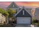 Charming two-story home with stone accents, a well-manicured lawn, and a two car garage at 1313 Loggerhead Dr, Lancaster, SC 29720