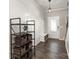 Inviting foyer with hardwood floors, coat rack bench, and stylish lighting fixture at 1313 Loggerhead Dr, Lancaster, SC 29720
