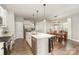 Bright, open kitchen features stainless steel appliances, island with seating, and view to dining area at 1313 Loggerhead Dr, Lancaster, SC 29720