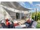 Relaxing patio with a shade, built-in grill, comfortable seating, and outdoor lights for evening gatherings at 1313 Loggerhead Dr, Lancaster, SC 29720