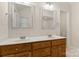 Bathroom featuring double sinks with wood cabinets and framed mirrors at 1325 Red Oaks Dr, Rock Hill, SC 29730