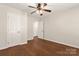Bedroom with hardwood floors, ceiling fan, and multiple closets at 1325 Red Oaks Dr, Rock Hill, SC 29730