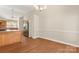 Bright dining area showcasing wood floors and a chandelier, adjacent to a spacious kitchen with modern appliances at 1325 Red Oaks Dr, Rock Hill, SC 29730