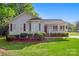 Charming single-story home featuring red shutters, a covered porch, and a lush green lawn at 1325 Red Oaks Dr, Rock Hill, SC 29730