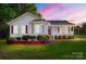 Charming single-story home featuring red shutters, a covered porch, and a lush green lawn at 1325 Red Oaks Dr, Rock Hill, SC 29730