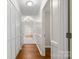 Hallway with wood floors, leading to various rooms and closet storage at 1325 Red Oaks Dr, Rock Hill, SC 29730