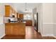 Spacious kitchen with stainless steel refrigerator, natural wood cabinets, and granite countertops at 1325 Red Oaks Dr, Rock Hill, SC 29730
