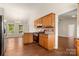 Well-lit kitchen features wooden cabinetry, stainless steel gas range, and a view into the bright dining area at 1325 Red Oaks Dr, Rock Hill, SC 29730
