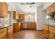 Well-lit kitchen features natural wood cabinets, tile backsplash, stainless steel dishwasher, and granite countertops at 1325 Red Oaks Dr, Rock Hill, SC 29730