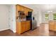 Kitchen featuring wooden cabinets, stainless steel refrigerator and microwave, next to well-lit dining area at 1325 Red Oaks Dr, Rock Hill, SC 29730