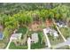 Expansive aerial view showcasing multiple homes with lush, green lawns and mature trees at 137 Brawley Woods Ln, Mooresville, NC 28115