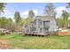 Aerial view of the home's backyard with deck, firepit and mature trees in a serene setting at 137 Brawley Woods Ln, Mooresville, NC 28115
