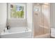 Bathroom featuring a large soaking tub and a tiled shower with a glass door at 137 Brawley Woods Ln, Mooresville, NC 28115