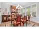 Elegant dining room with glass-top table, upholstered chairs, and window at 137 Brawley Woods Ln, Mooresville, NC 28115