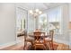 Bright dining room with hardwood floors, windows, and round wood table with seating for four at 137 Brawley Woods Ln, Mooresville, NC 28115